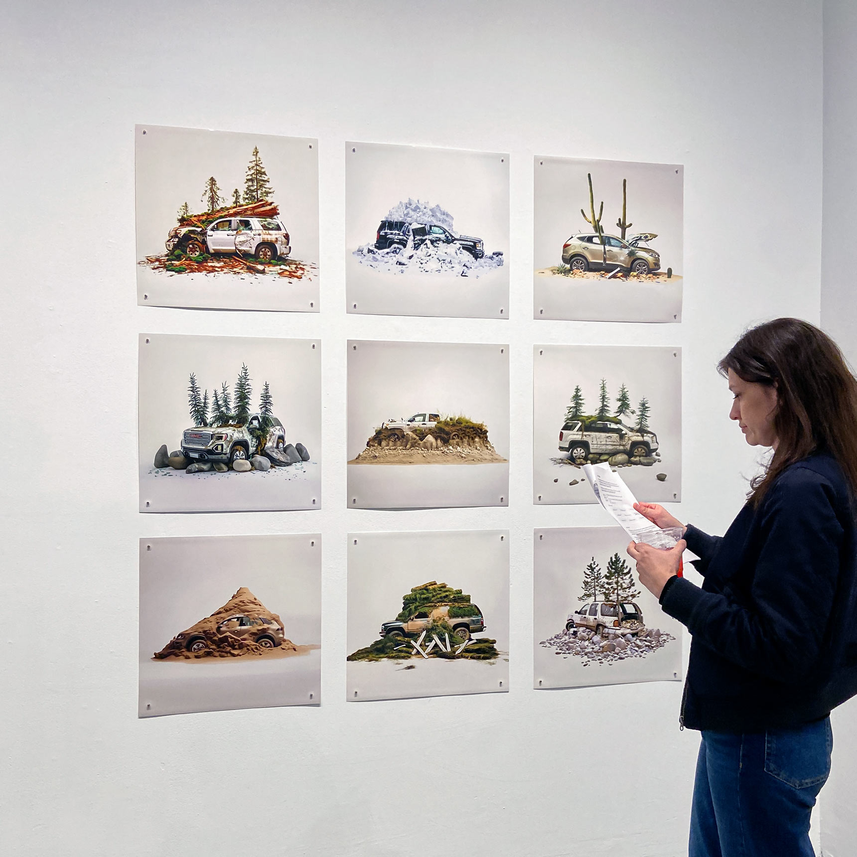 Woman in an art gallery looking at a grid of 9 Auto Repair prints