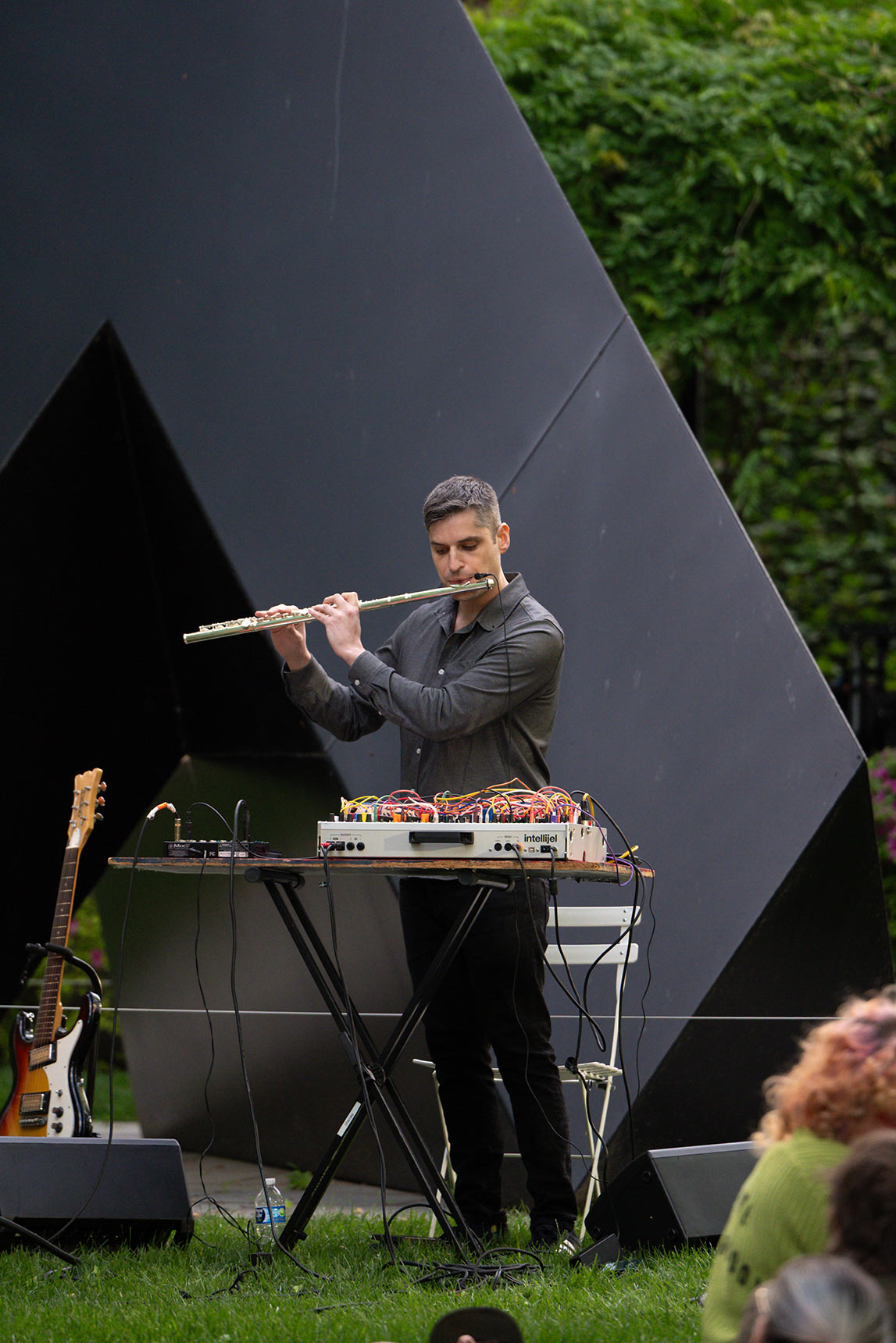 Jess Keyes playing flute in the BMA Sculpture Garden