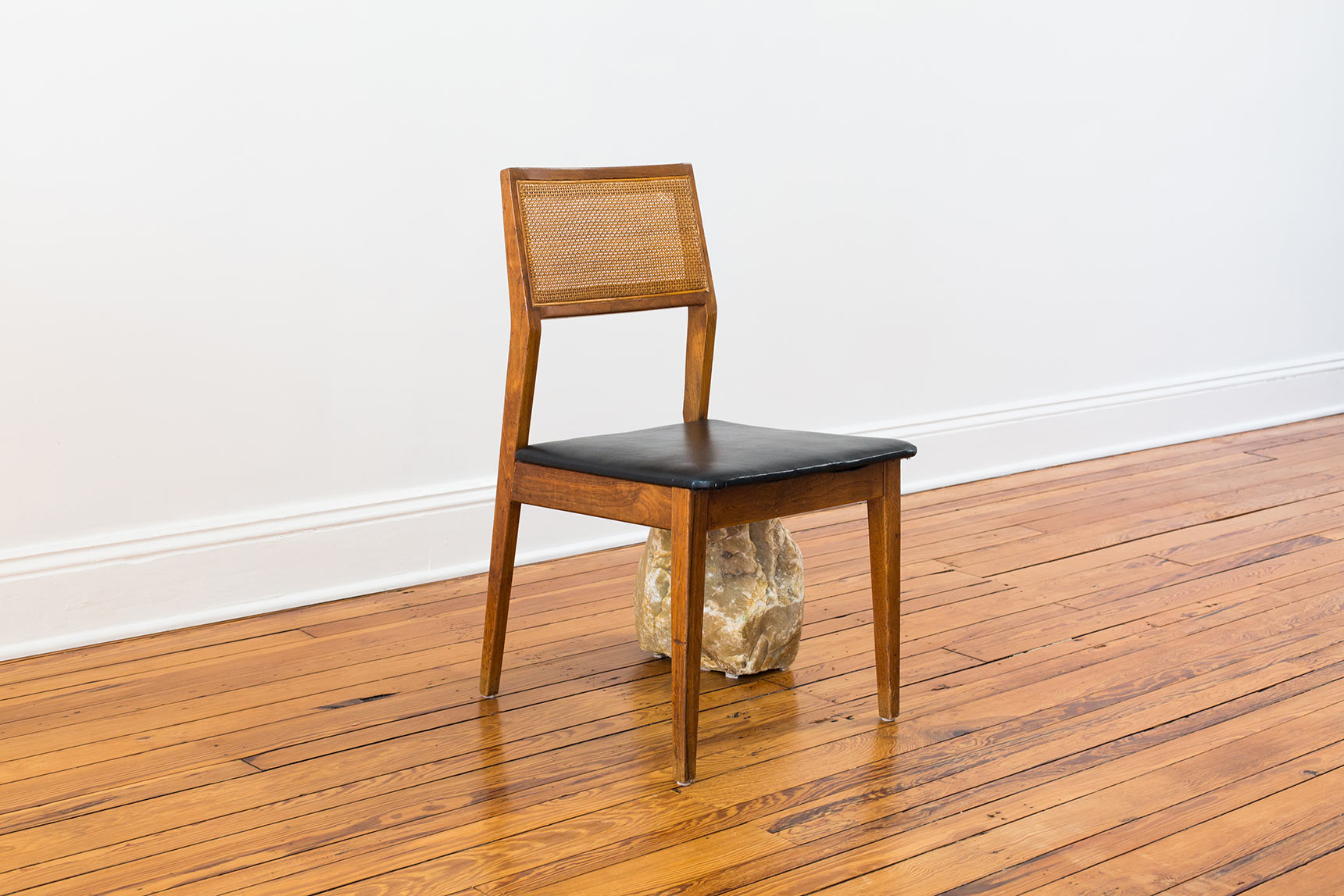 Codependent Chair, a chair with one broken-off leg supported by a large rock